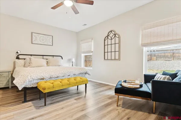 a bedroom with a bed window and a table