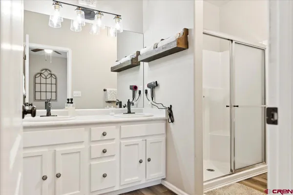 a bathroom with a double vanity sink and mirror