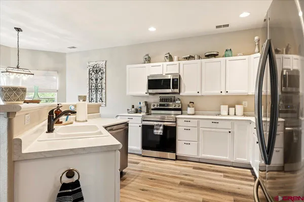 a kitchen with a sink stove and refrigerator