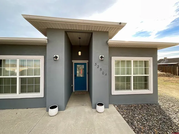 a front view of a house with a large window