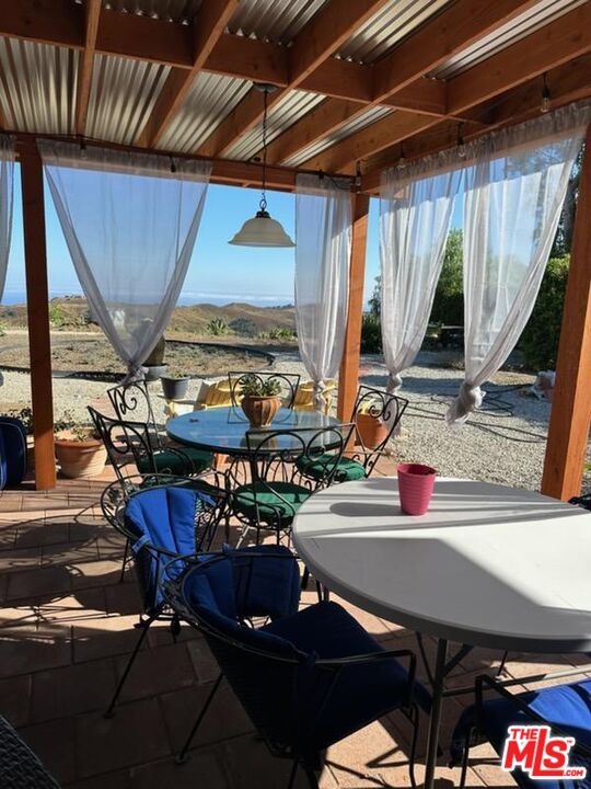 1710 Decker Road Malibu, CA 90265 - Photo 15 of 23 a view of a dining room with furniture and window