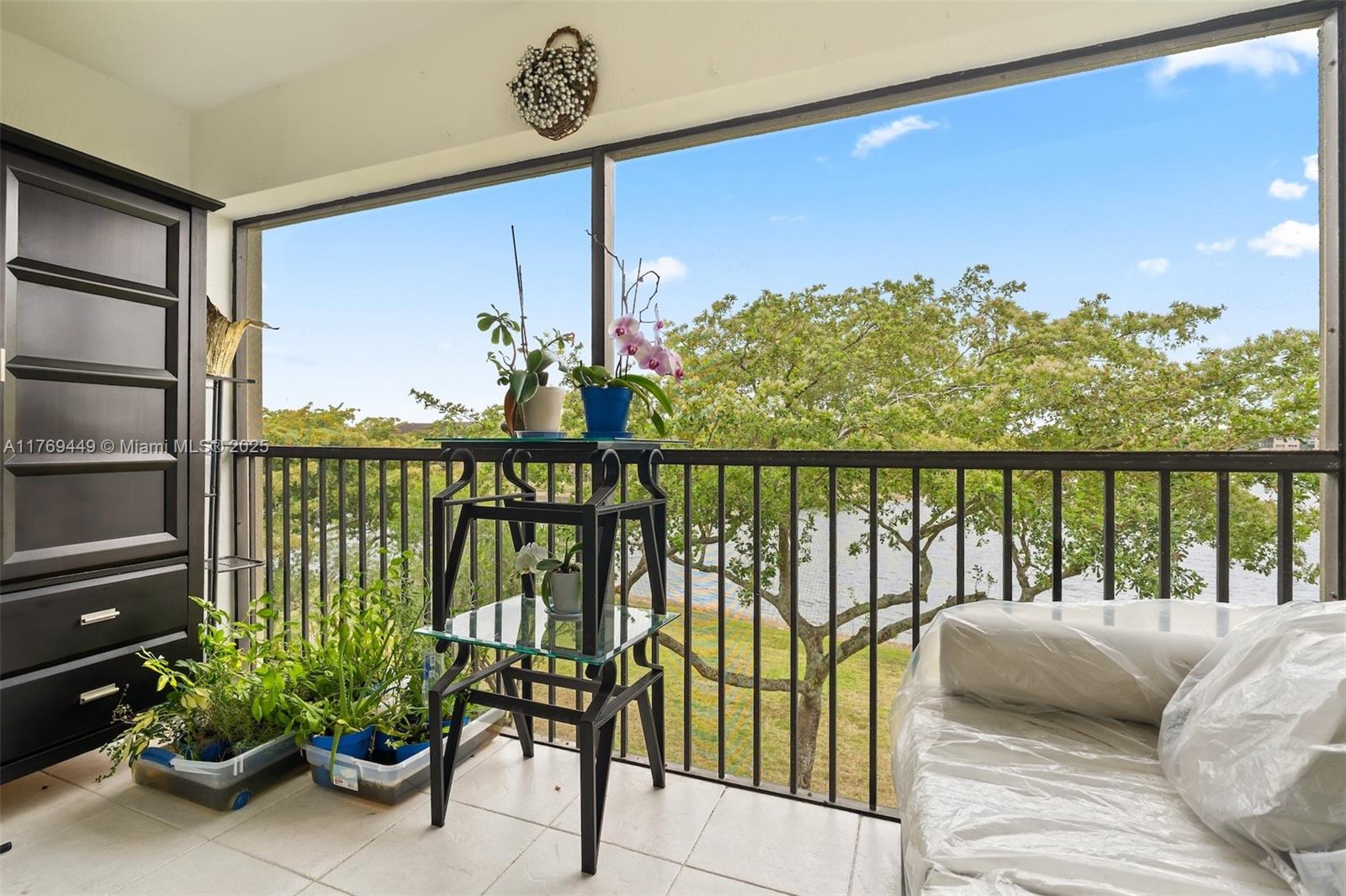 901 Southwest 141st Avenue, Unit 409M Pembroke Pines, FL 33027 - Photo 1 of 30 a balcony with furniture and a potted plant