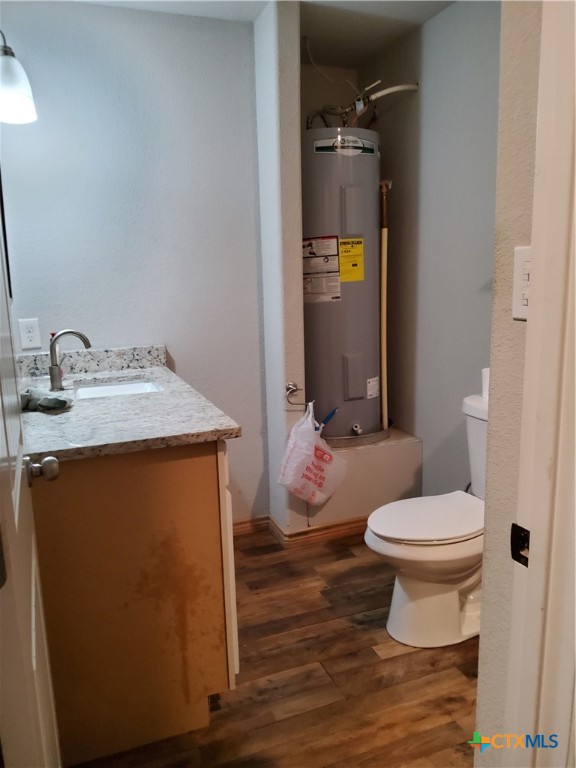1601 County Road 153 Evant, TX 76525 - Photo 13 of 25 a bathroom with a granite countertop toilet and a sink