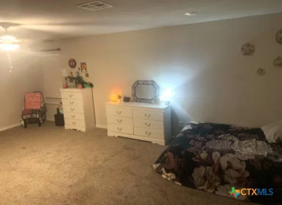 a bedroom with a bed and cabinets