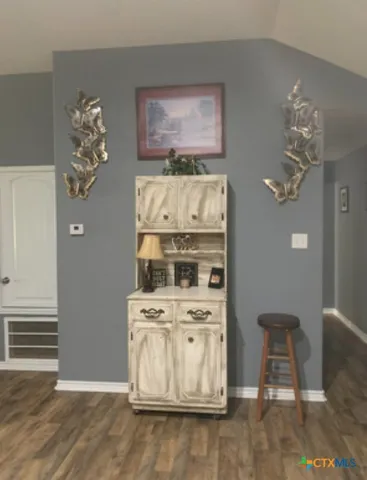a white kitchen with a stove top oven