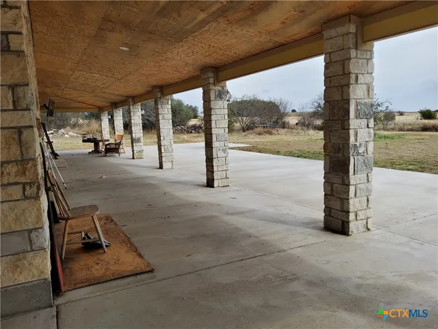 a view of a house with backyard porch and sitting area