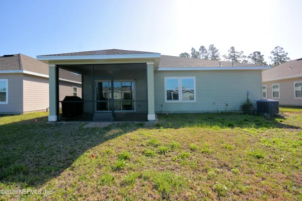 a view of a house with swimming pool and sitting area