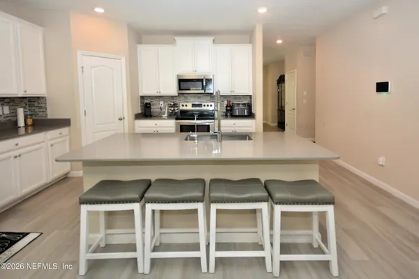 a kitchen with stainless steel appliances a stove a sink and a refrigerator