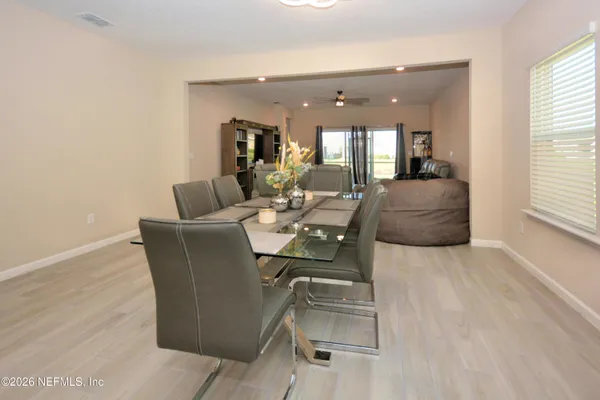 a living room with furniture and a ceiling fan