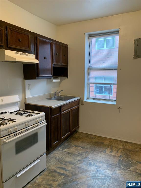 5616 Hudson Avenue, Unit 1D West New York, NJ 07093 - Photo 2 of 11 a kitchen with stainless steel appliances a stove and a microwave