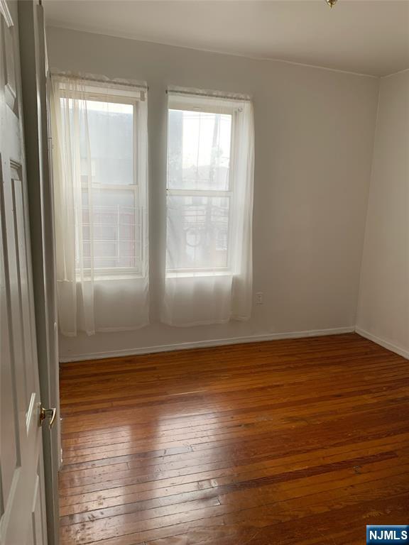 5616 Hudson Avenue, Unit 1D West New York, NJ 07093 - Photo 5 of 11 a view of wooden floor and windows in a room
