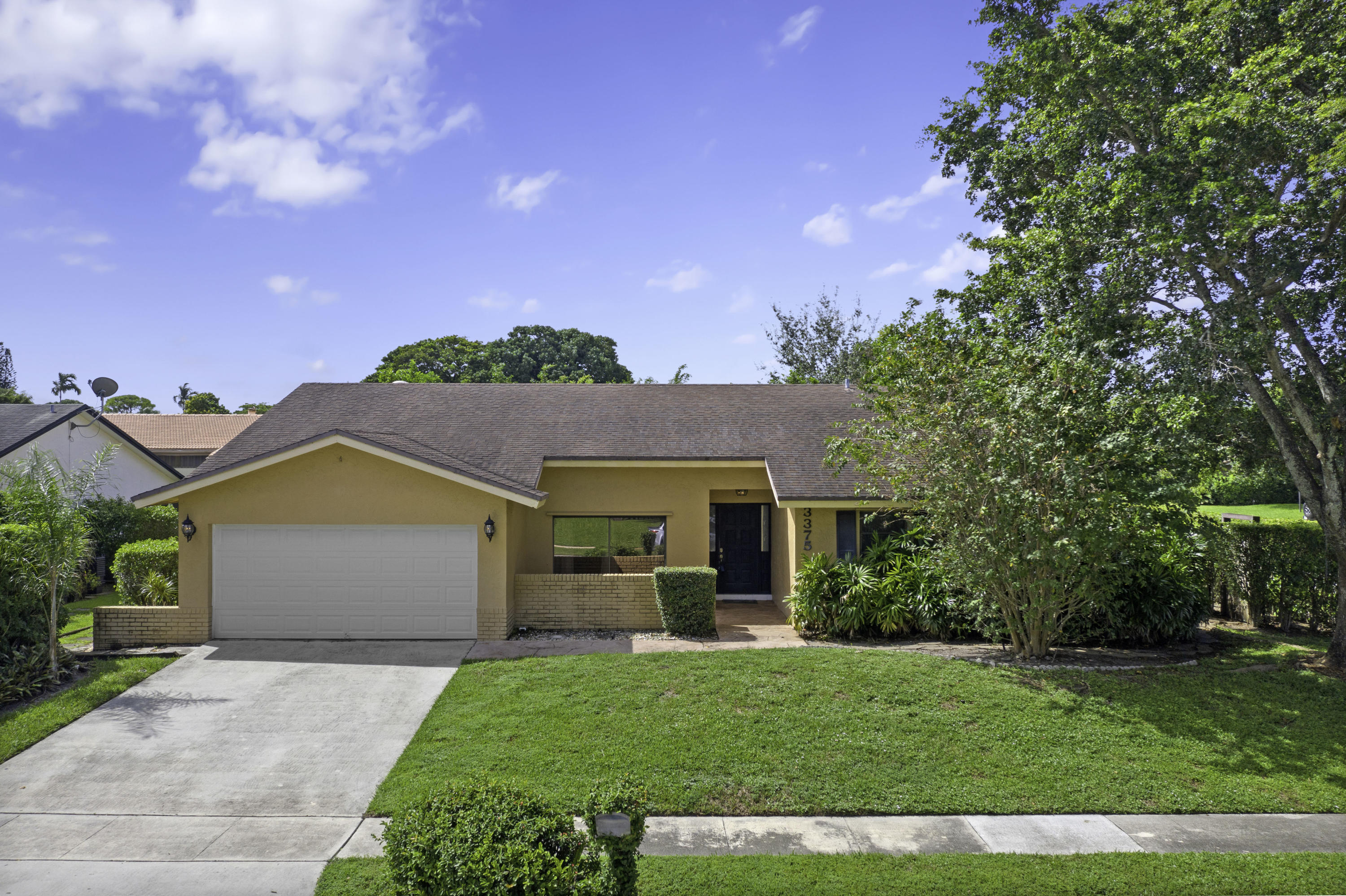 3375 Northwest 27th Avenue Boca Raton, FL 33434 - Photo 1 of 27 a view of a house with a garden