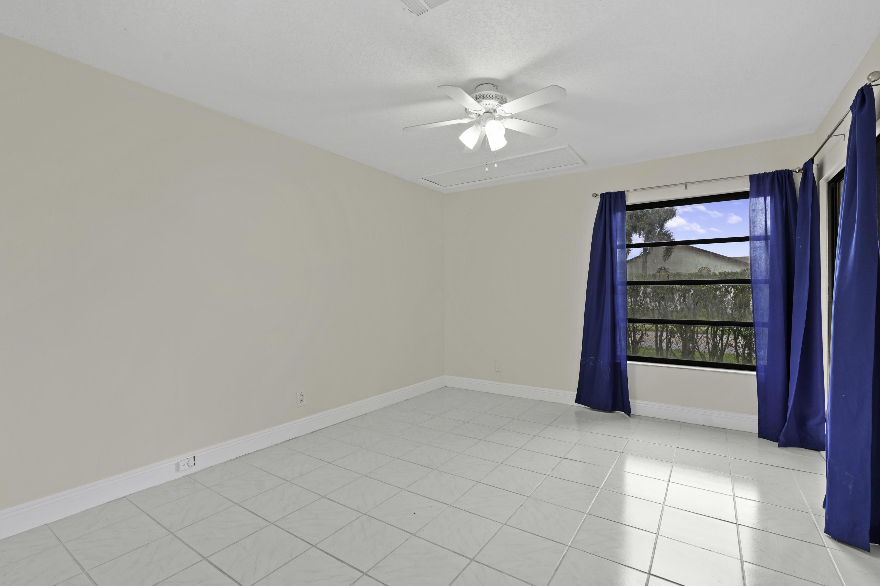 3375 Northwest 27th Avenue Boca Raton, FL 33434 - Photo 12 of 27 a view of an empty room with a window