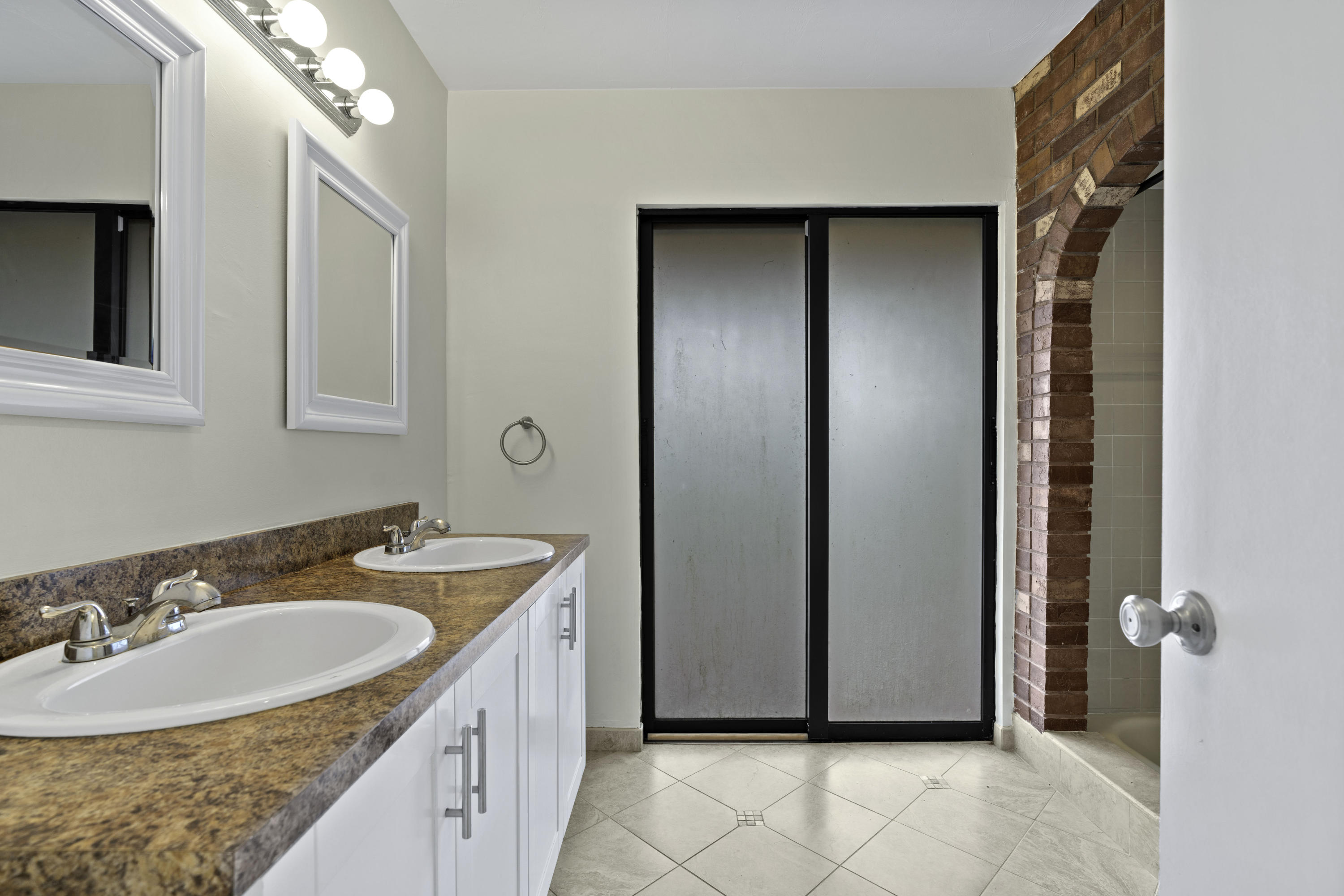 3375 Northwest 27th Avenue Boca Raton, FL 33434 - Photo 13 of 27 a bathroom with a sink double vanity and a mirror