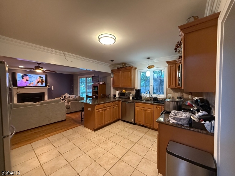 a large kitchen with a lot of counter top space and stainless steel appliances