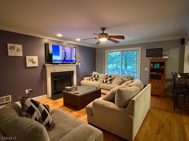 531 Harris Avenue Middlesex, NJ 08846 - Photo 11 of 19 a living room with furniture a fireplace and a flat screen tv