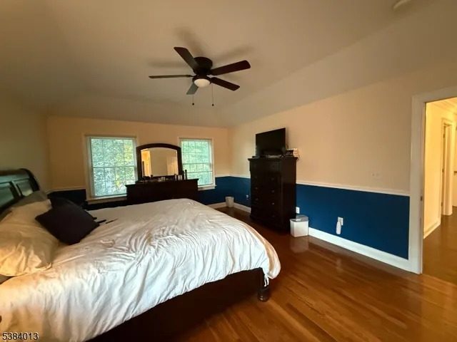 a bedroom with a bed dresser and a window