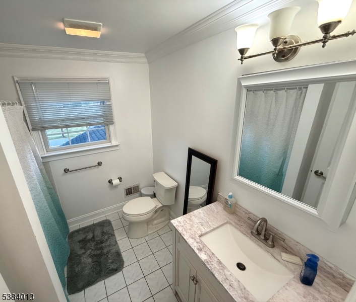 531 Harris Avenue Middlesex, NJ 08846 - Photo 7 of 19 a bathroom with a sink a toilet and mirror
