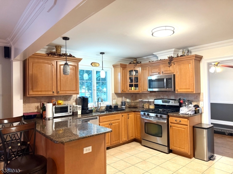 531 Harris Avenue Middlesex, NJ 08846 - Photo 10 of 19 a kitchen with stainless steel appliances granite countertop a sink stove and refrigerator