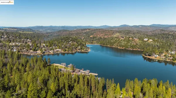 an aerial view of a house with a lake view