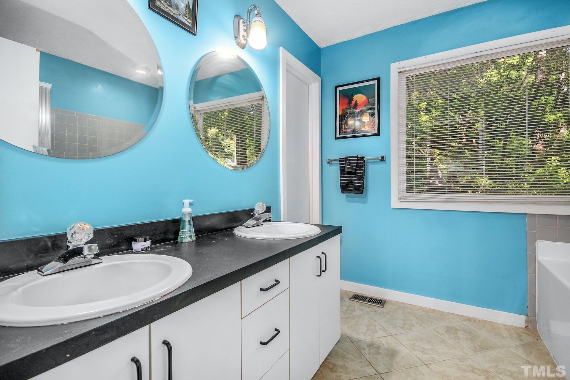 4605 Batavia Court Raleigh, NC 27604 - Photo 11 of 18 a bathroom with a granite countertop sink and a mirror