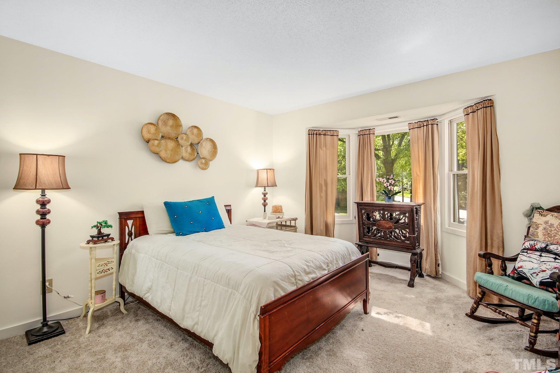 4605 Batavia Court Raleigh, NC 27604 - Photo 14 of 18 a bedroom with a bed and a table