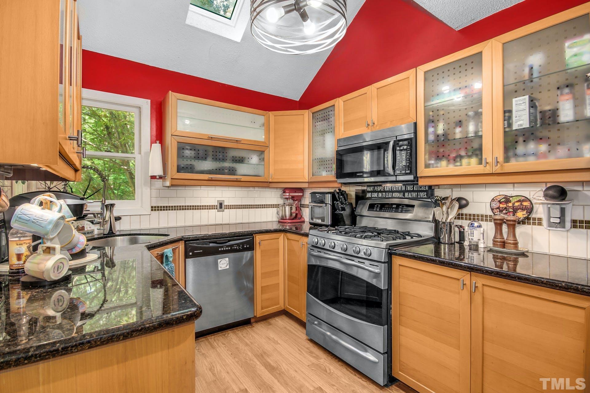 4605 Batavia Court Raleigh, NC 27604 - Photo 7 of 18 a kitchen with stainless steel appliances granite countertop a stove and a sink