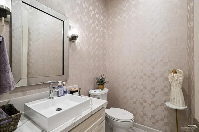 a utility room with sink dryer and washer