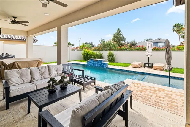 a view of a patio with swimming pool table and chairs