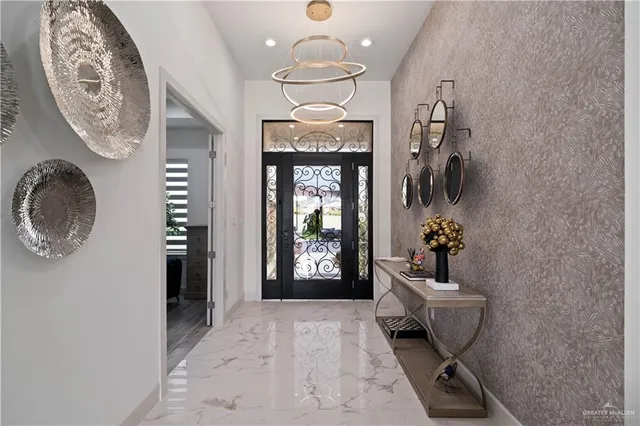 a living room with furniture ceiling fan and a large window