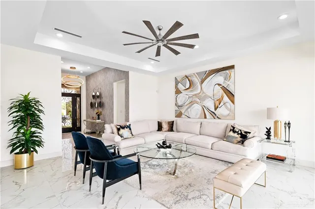 a living room with furniture a chandelier and a window