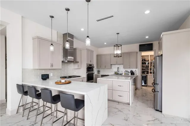 a kitchen with a stove a refrigerator and a sink