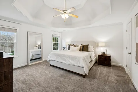 a bedroom with a large bed and a chandelier