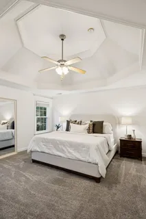 a bedroom with a bed and a chandelier