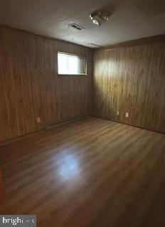 21628 Great Mills Road, Unit F2 Lexington Park, MD 20653 - Photo 4 of 5 an empty room with wooden floor and windows with curtains