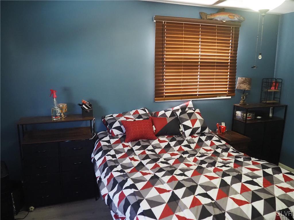 147 Williams Road Cresco, PA 18326 - Photo 13 of 35 a bed sitting in a bedroom next to a window and dresser