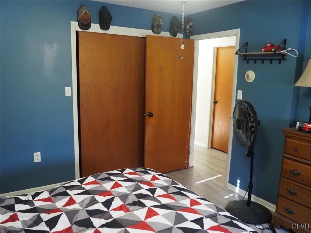 147 Williams Road Cresco, PA 18326 - Photo 14 of 35 a bedroom with a bed and wooden floor
