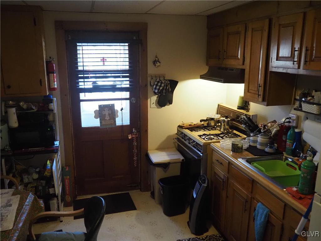 147 Williams Road Cresco, PA 18326 - Photo 22 of 35 a kitchen with a stove and a wooden floor