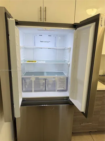 a kitchen with a refrigerator and a window