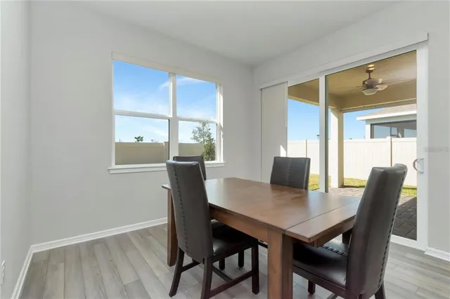 a view of a dining room with a table and chairs