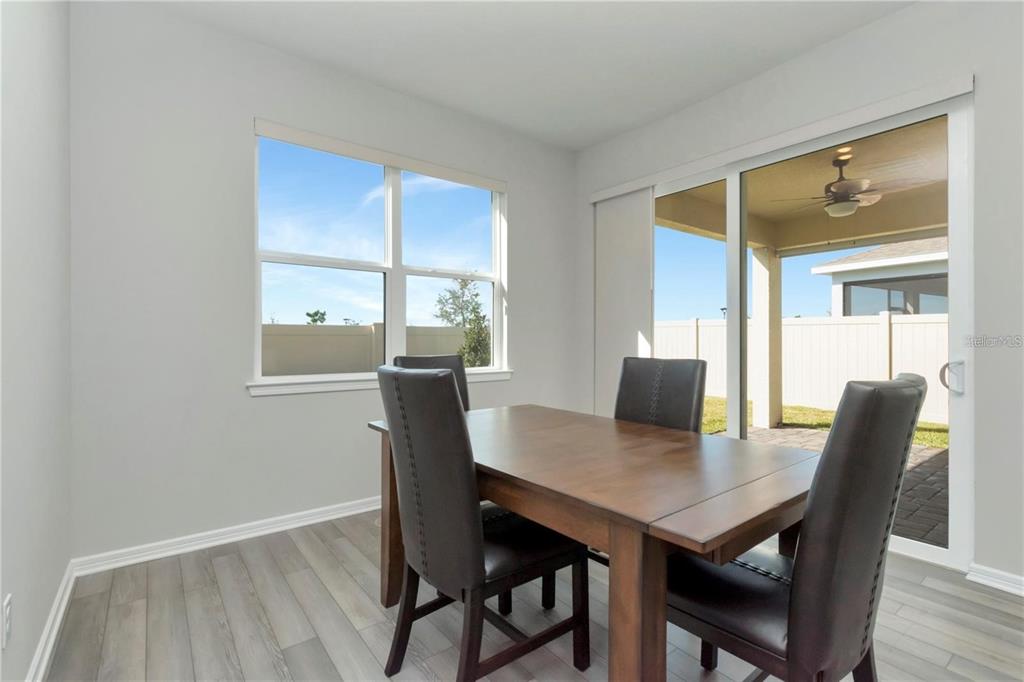 1991 Spring Shower Circle Kissimmee, FL 34744 - Photo 12 of 51 a view of a dining room with a table and chairs