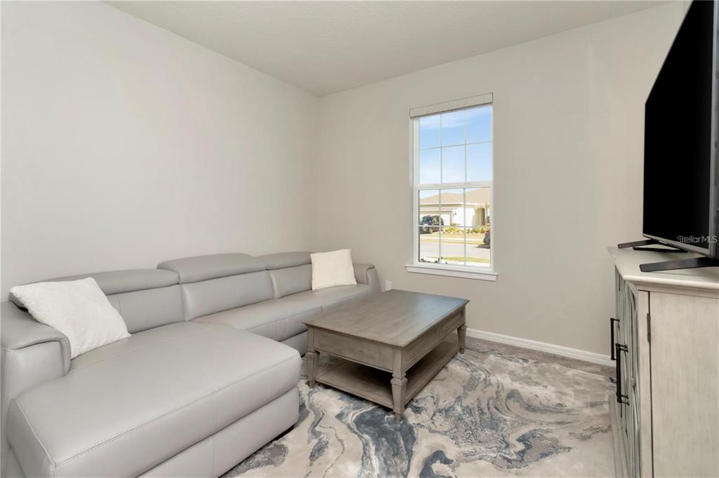 1991 Spring Shower Circle Kissimmee, FL 34744 - Photo 17 of 51 a living room with furniture and a flat screen tv