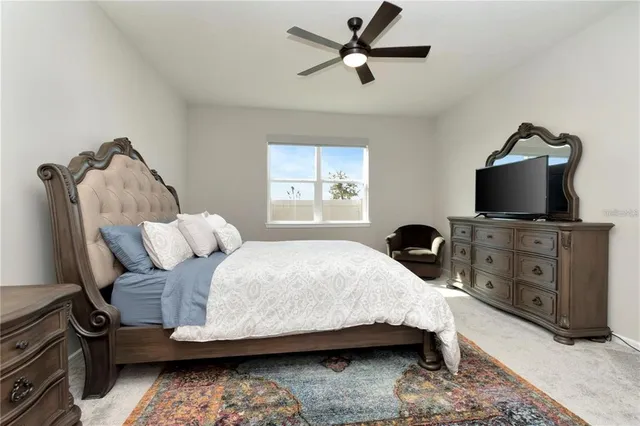 a bedroom with bed and window