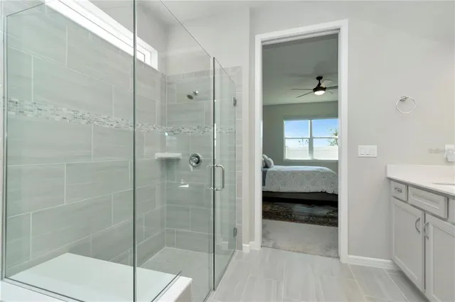 a bathroom with a shower and a sink