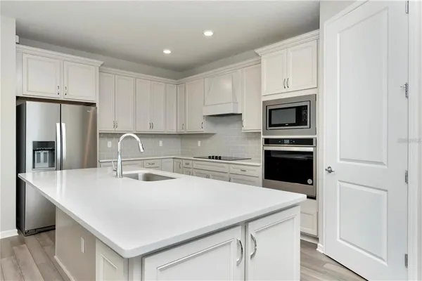 a kitchen with a sink a stove and refrigerator