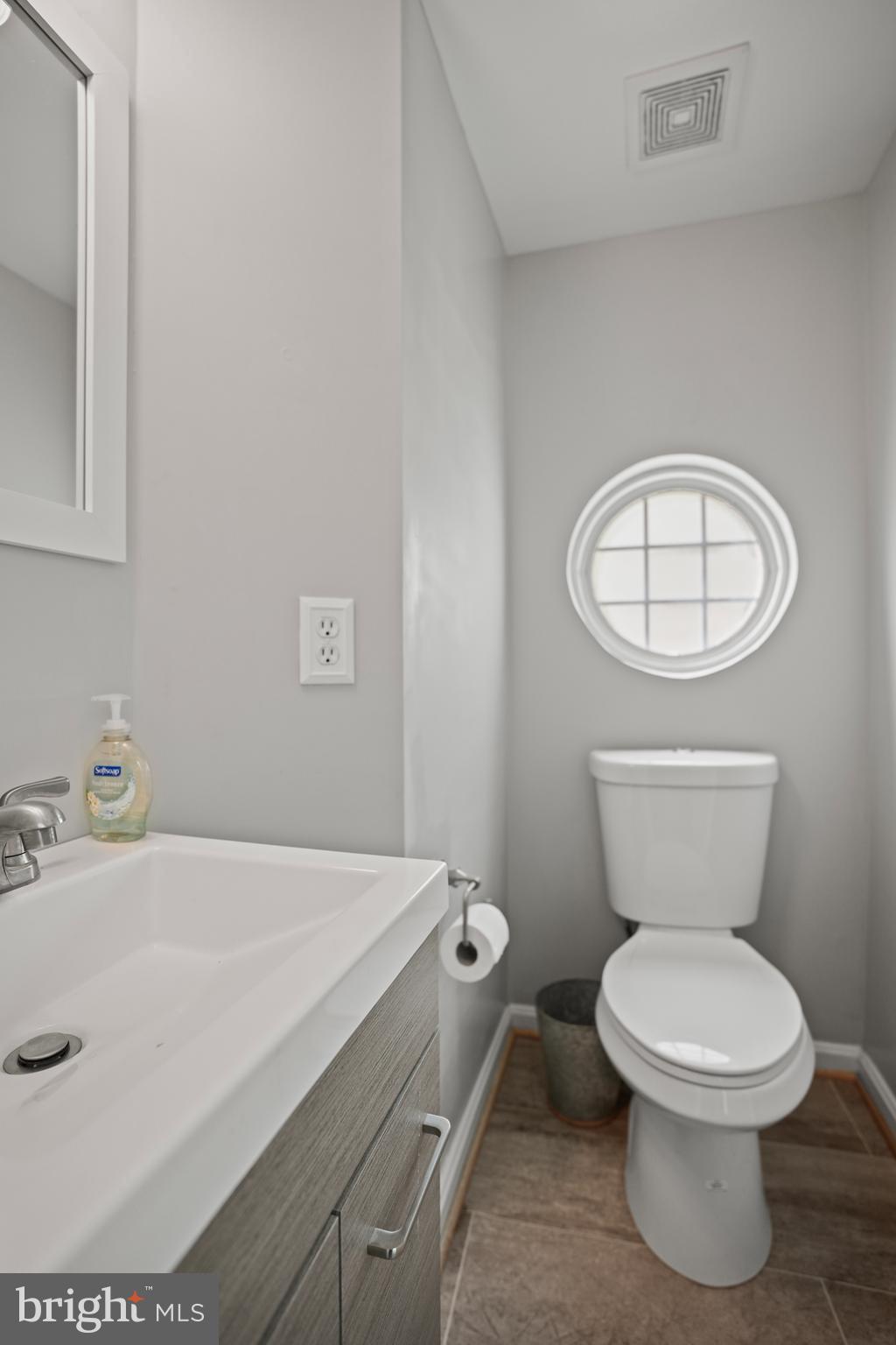 3915 Red Deer Circle Randallstown, MD 21133 - Photo 11 of 30 a bathroom with a toilet a sink and a mirror