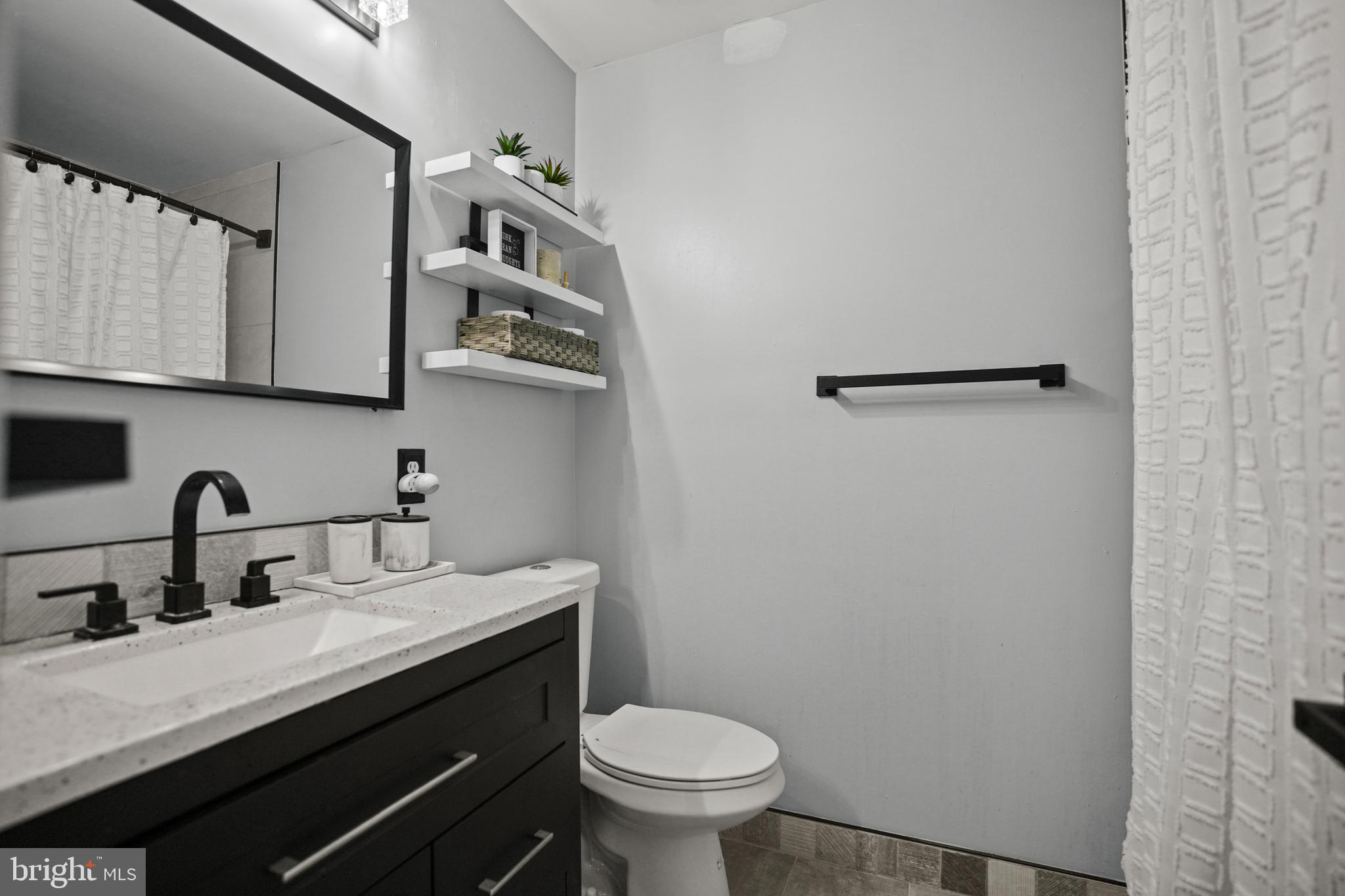 3915 Red Deer Circle Randallstown, MD 21133 - Photo 14 of 30 a bathroom with a granite countertop sink mirror and toilet