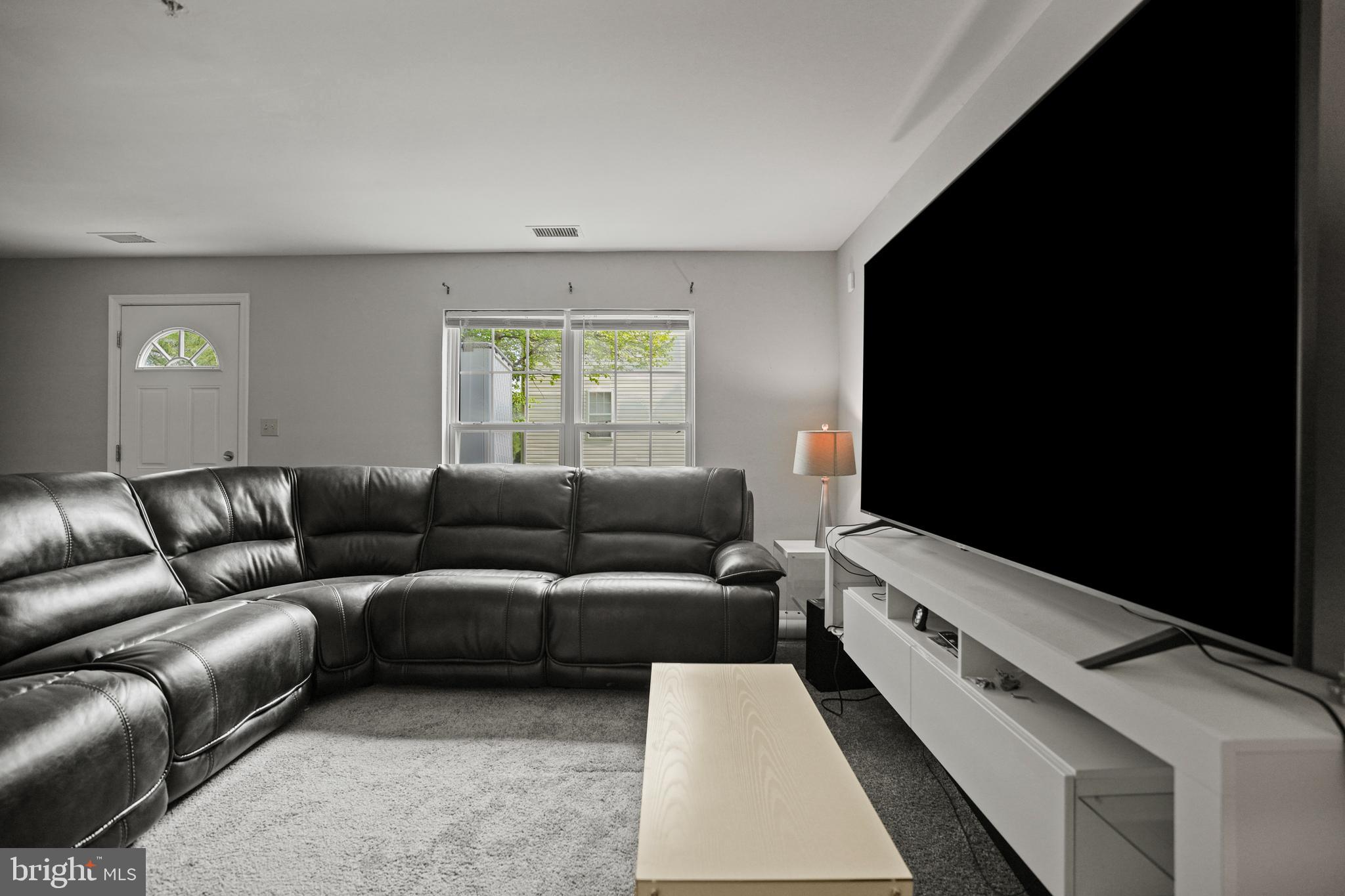 3915 Red Deer Circle Randallstown, MD 21133 - Photo 21 of 30 a living room with furniture and a flat screen tv