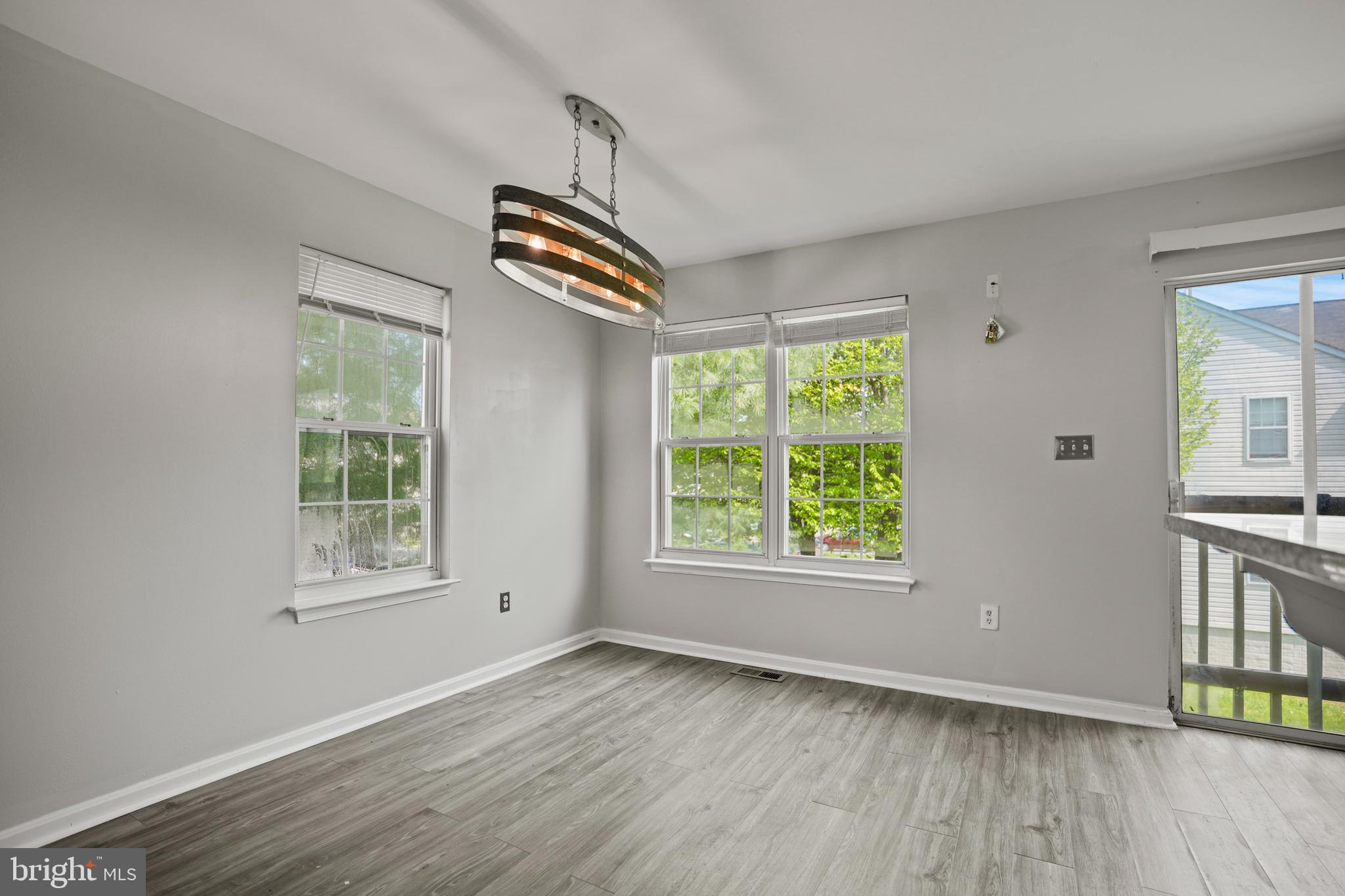 3915 Red Deer Circle Randallstown, MD 21133 - Photo 8 of 30 a view of an empty room with wooden floor and a window