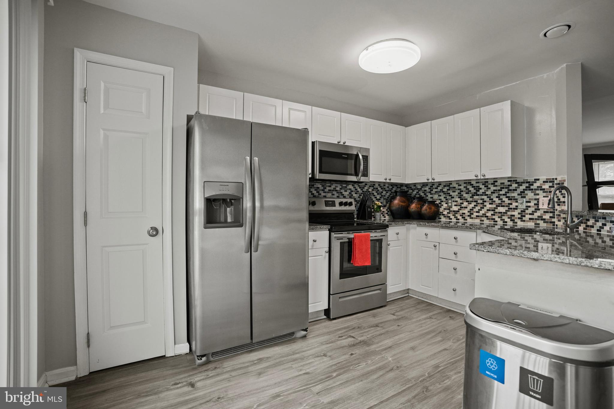 3915 Red Deer Circle Randallstown, MD 21133 - Photo 10 of 30 a kitchen with stainless steel appliances granite countertop a refrigerator and a stove top oven